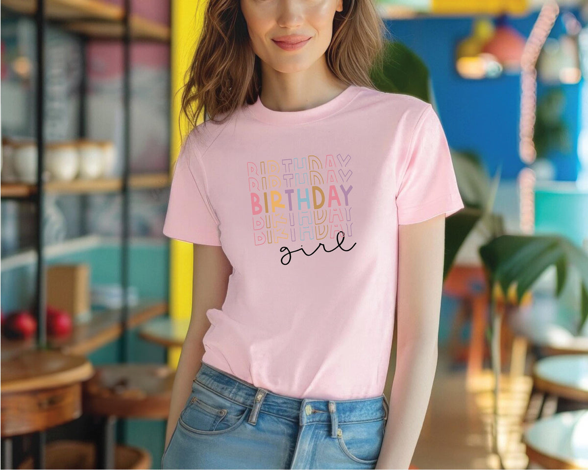 a woman wearing a pink birthday shirt and jeans