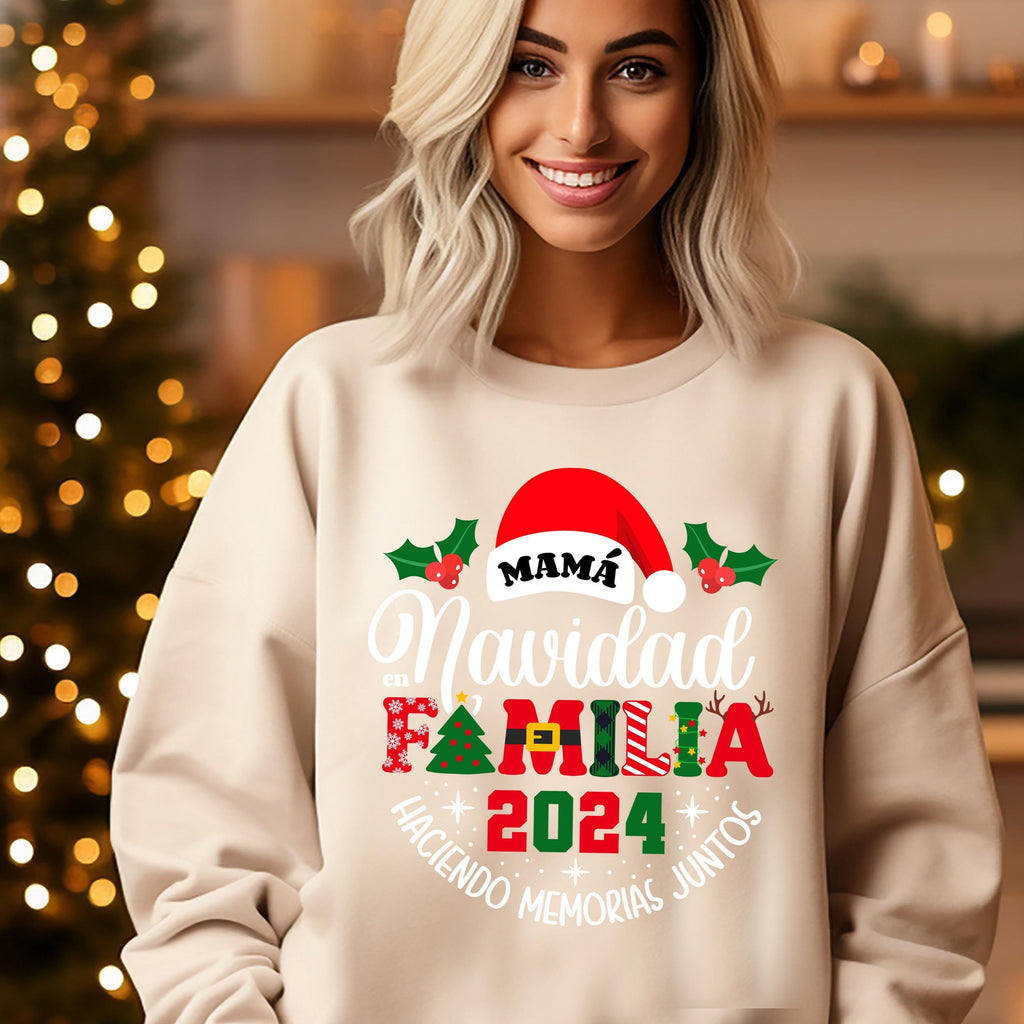 A smiling woman wearing a white sweater with a Christmas-themed design.