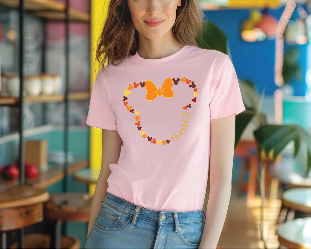 a woman wearing a pink mickey mouse t - shirt