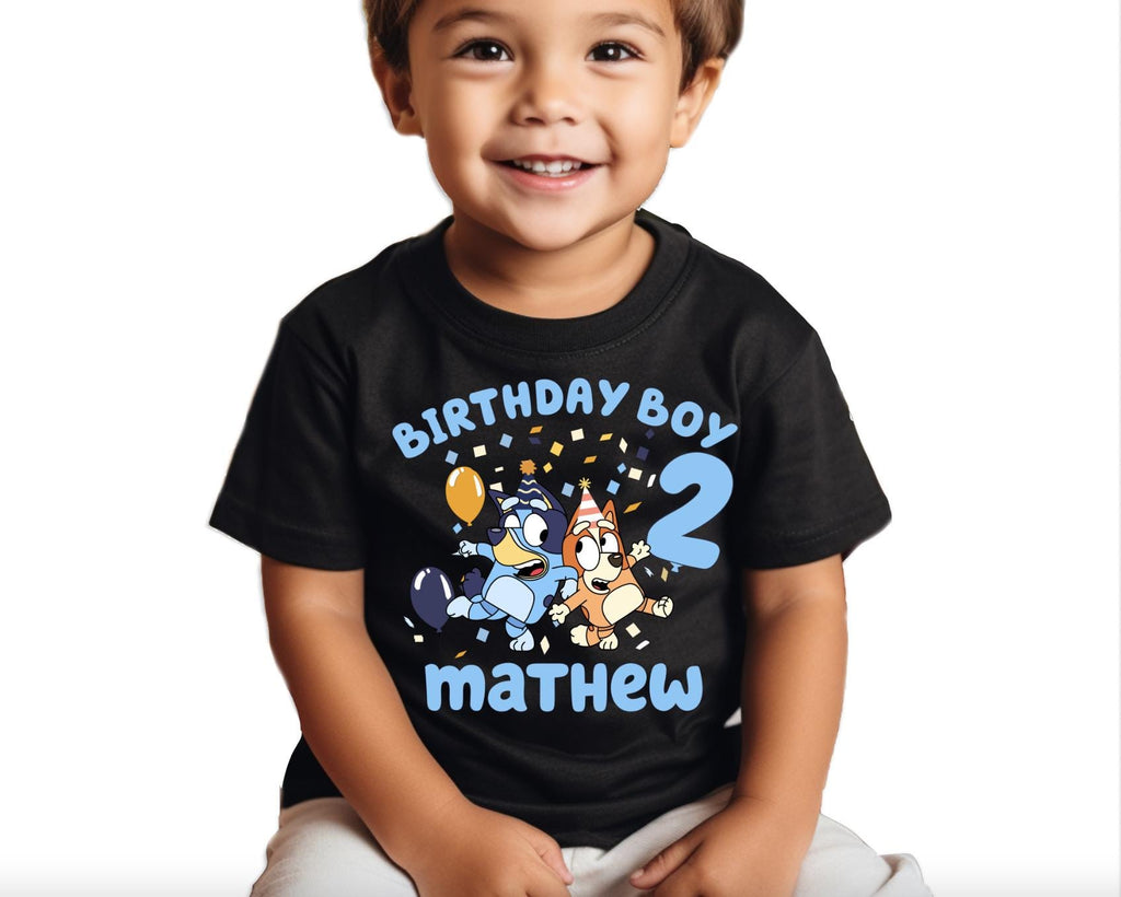 a young boy wearing a birthday boy shirt