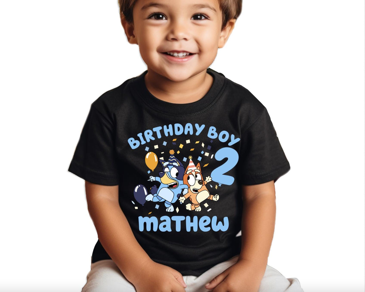 a young boy wearing a birthday boy shirt
