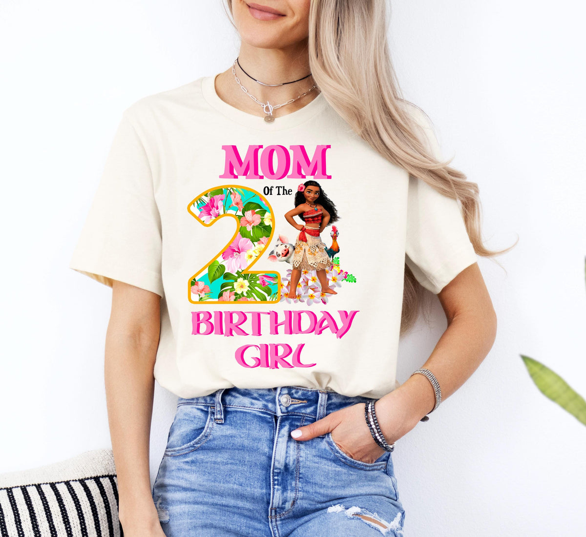 A woman wearing a white t-shirt with a graphic design and text printed on it.