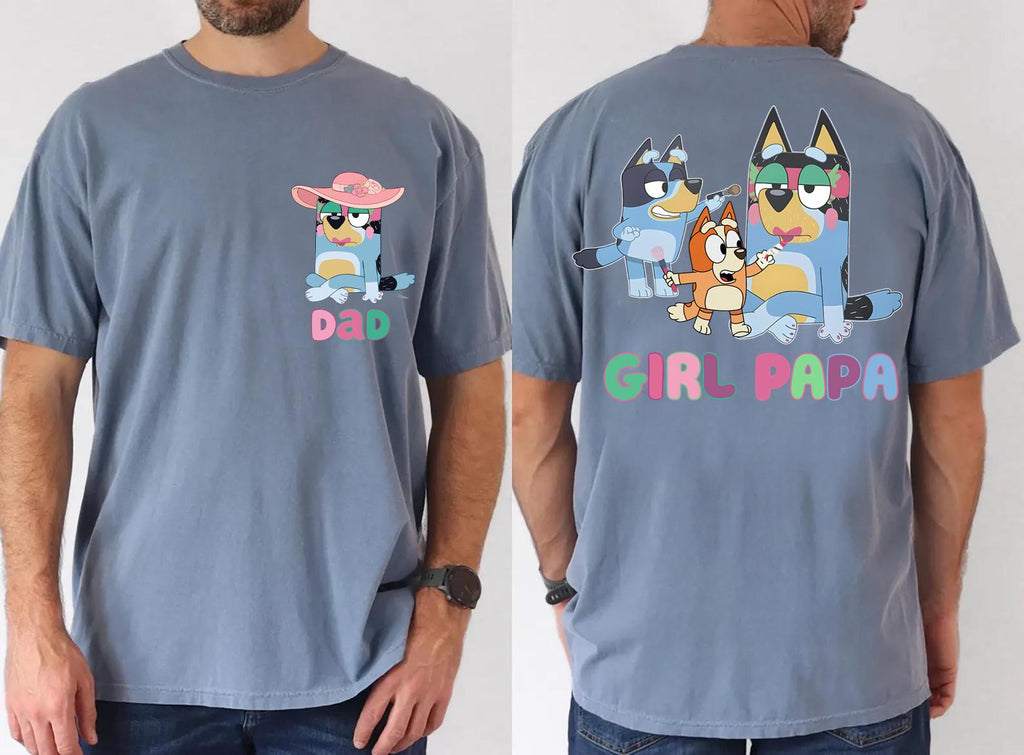 A man wearing a gray t-shirt with a graphic design featuring cartoon characters and the text "DAD" and "GIRL-PAPA" printed on the back.