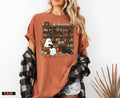 a woman wearing a brown shirt with a dog on it