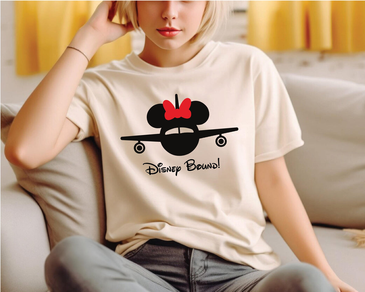 a woman sitting on a couch wearing a mickey mouse shirt