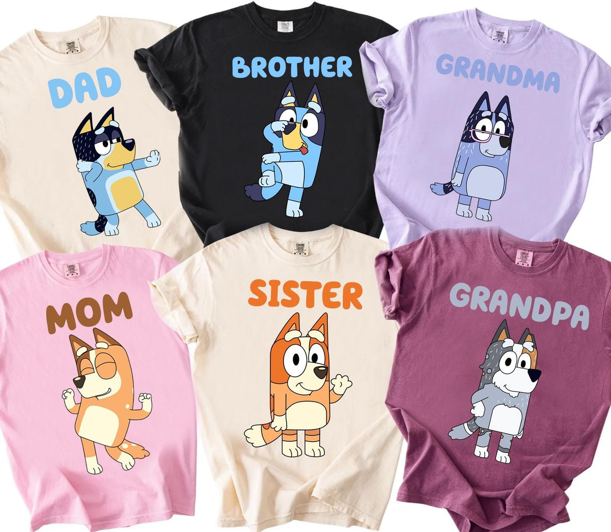 a collection of t-shirts featuring cartoon dogs and the text "DAD", "GRANDMA", "SISTER", and "MOM" printed on them.