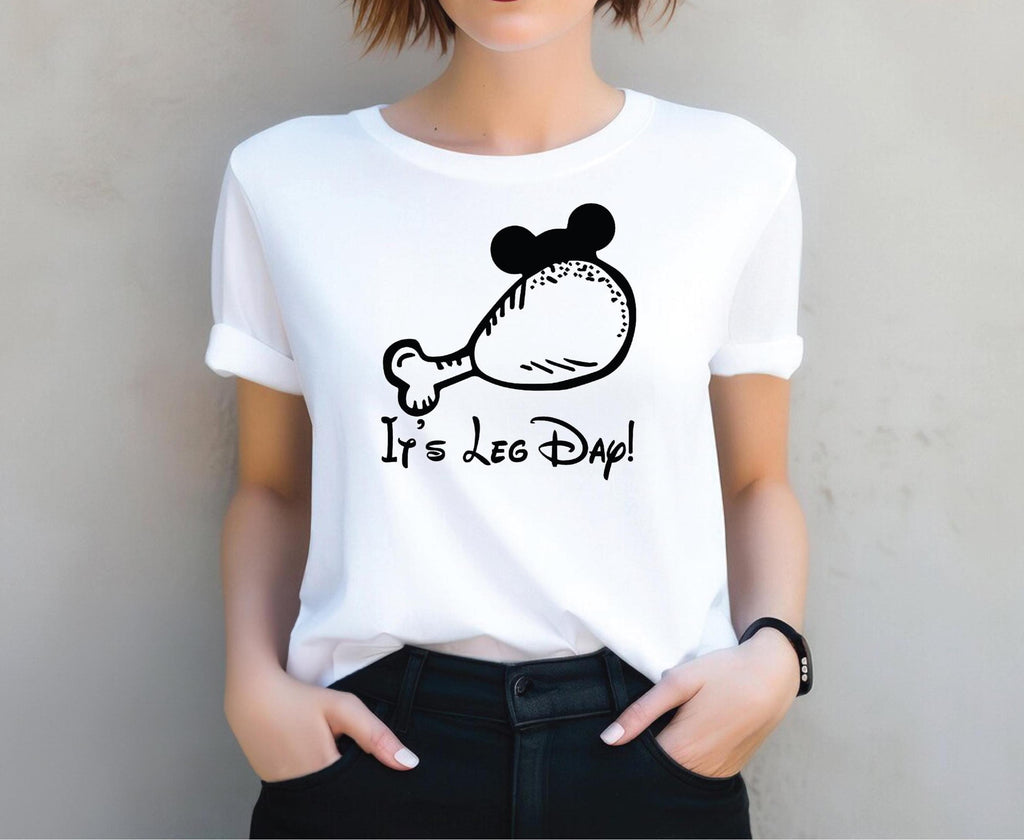 a woman wearing a white shirt with a mickey mouse on it