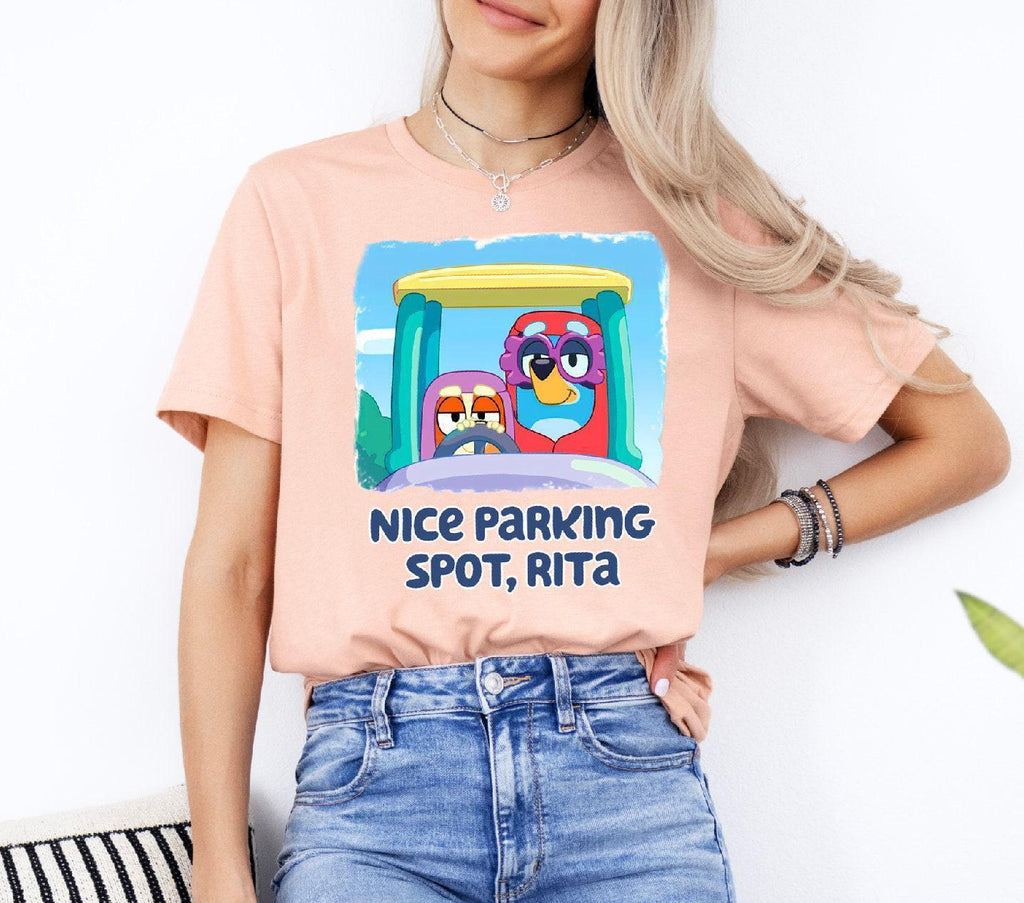 a woman wearing a pink tee shirt with an image of a cartoon character on it