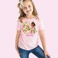 a little girl wearing a pink shirt with the number six on it