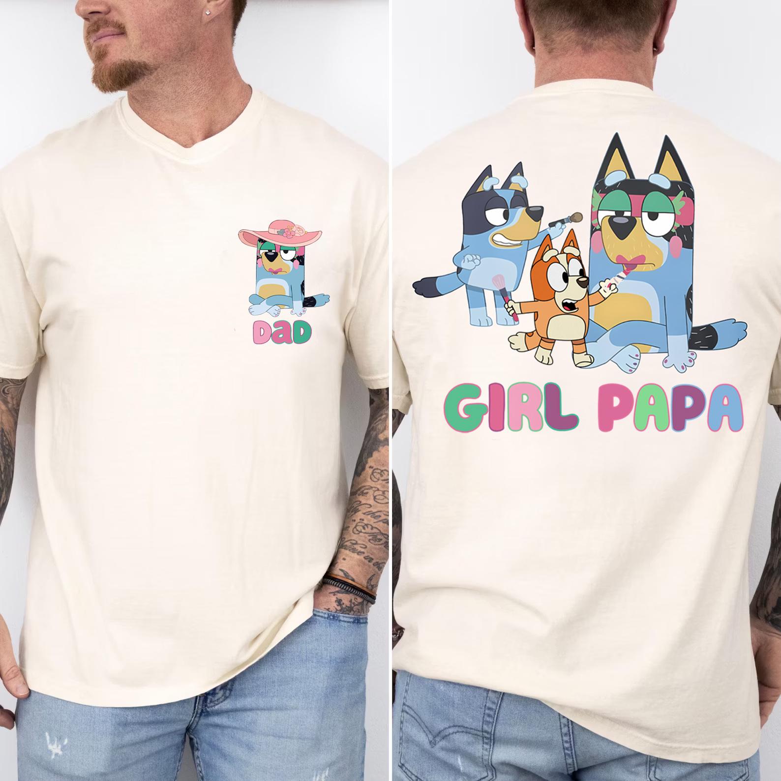 A man wearing a white t-shirt with a graphic of cartoon dogs and the text "DAD" and "GIRL PAPA" printed on it.