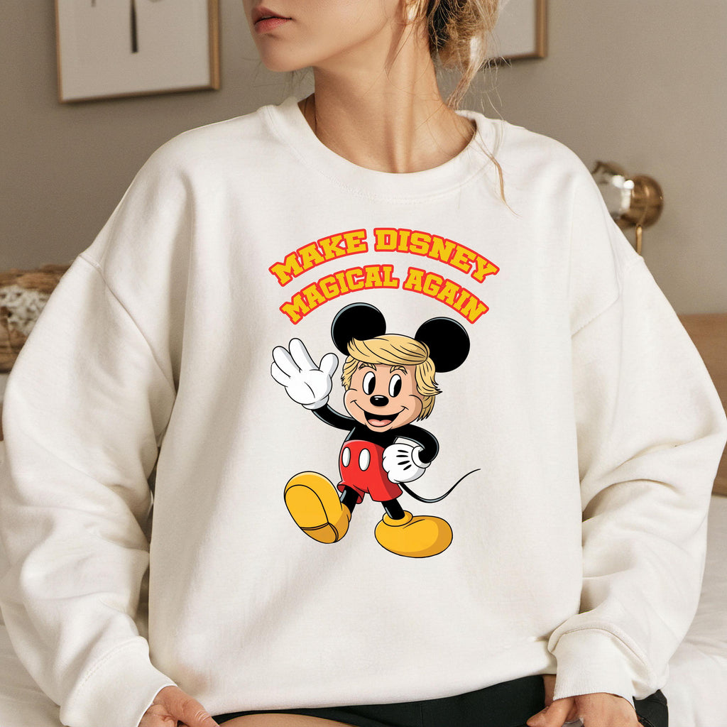 a woman sitting on a bed wearing a mickey mouse sweatshirt