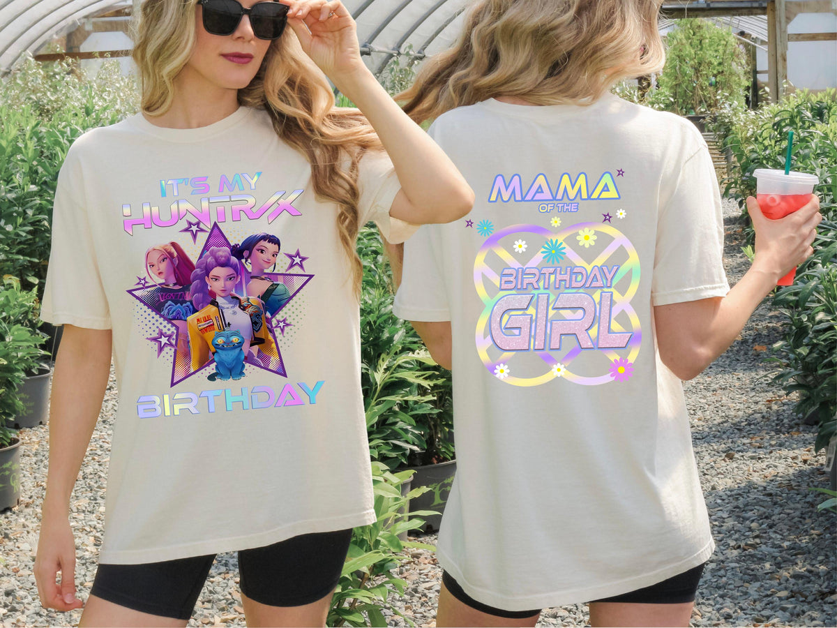 A woman wearing a white t-shirt with a colorful graphic design and text on the back.