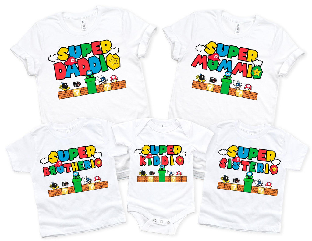five white t-shirts with the same design, featuring the text "SUPER MOMMIO" and various characters from the Super Mario video game franchise.
