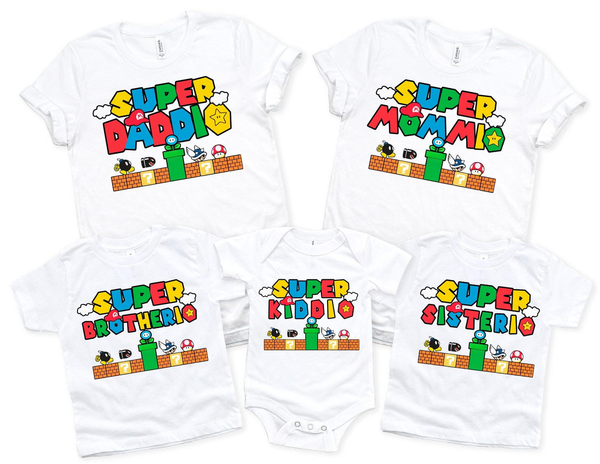 five white t-shirts with the same design, featuring the text "SUPER MOMMIO" and various characters from the Super Mario video game franchise.