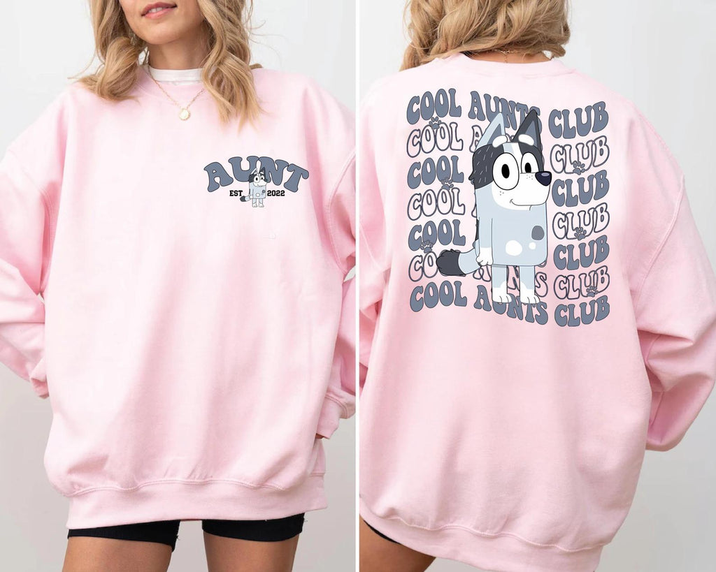 a woman wearing a pink sweatshirt and shorts
