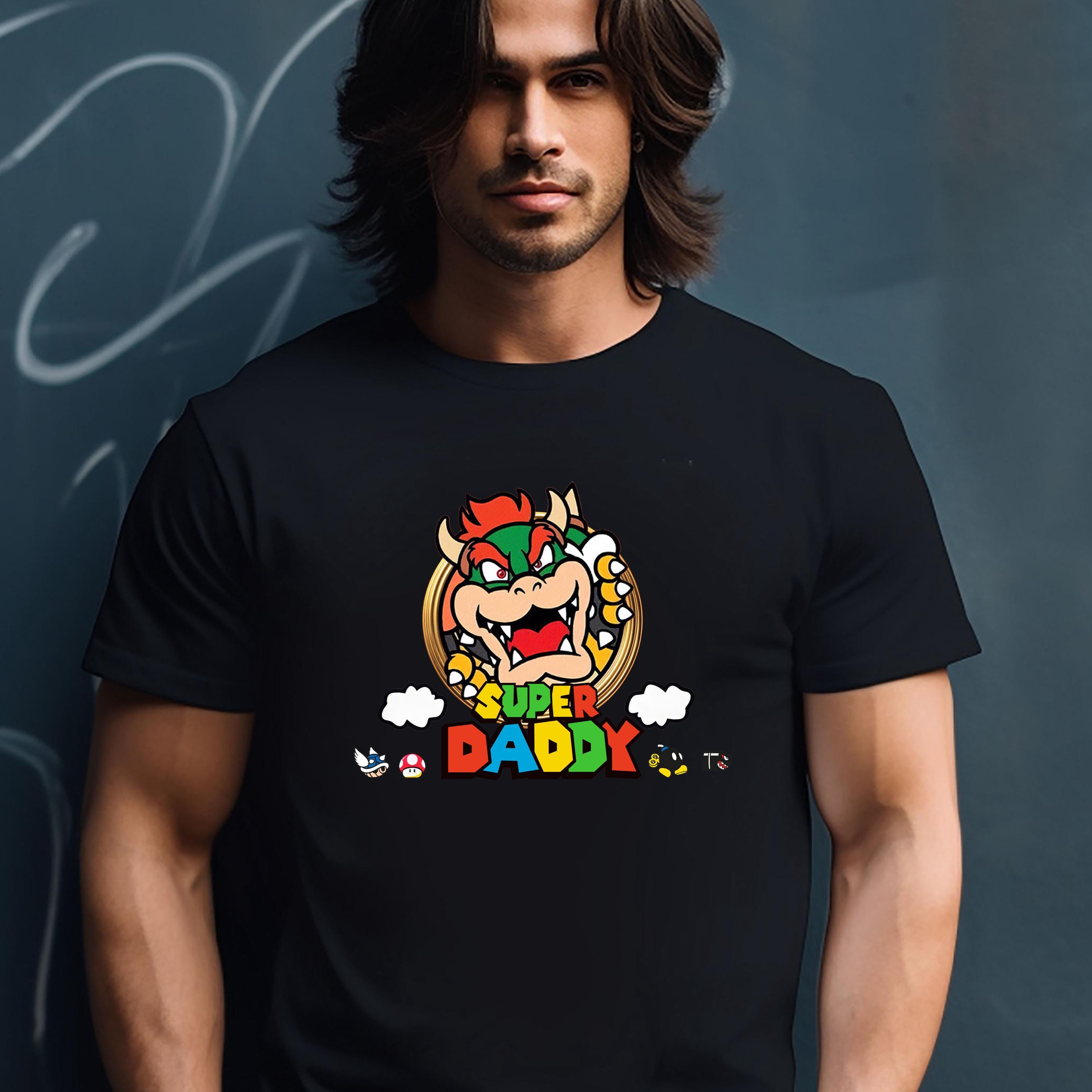 A man wearing a black t-shirt with a colorful graphic of a character from the Mario video game franchise.