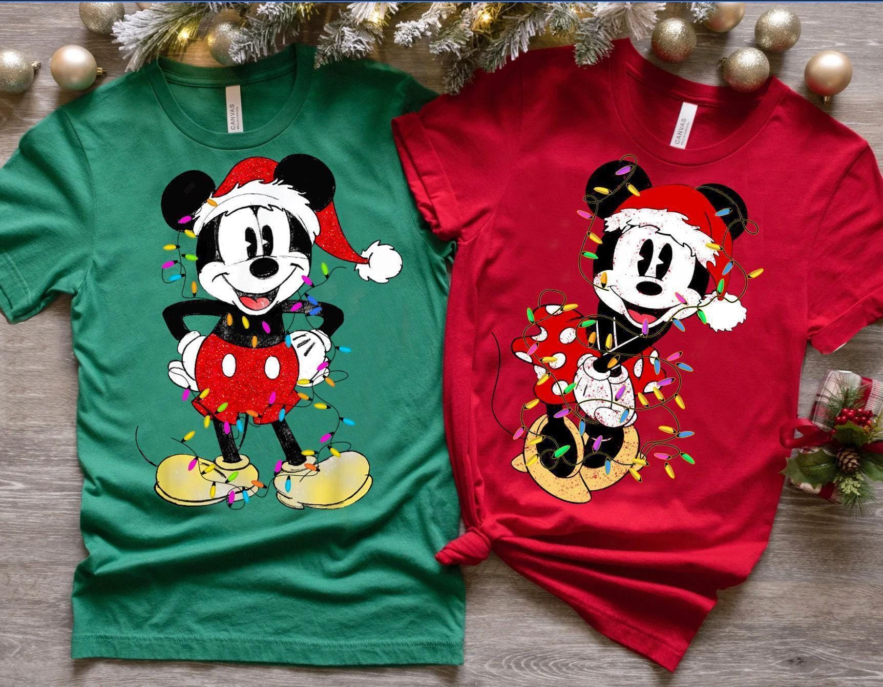 a man and woman wearing mickey and minnie mouse shirts