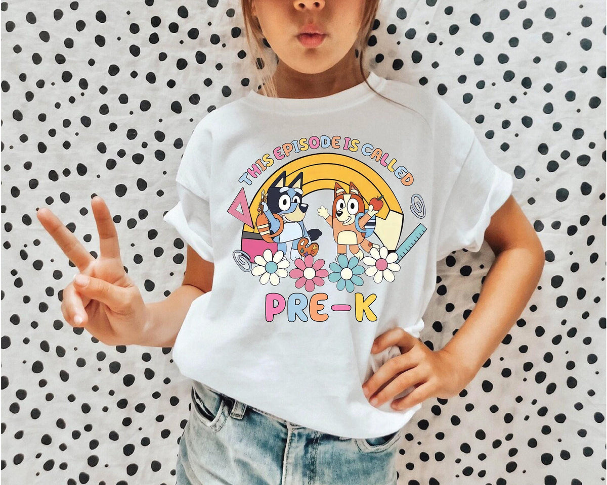 a young girl wearing a t - shirt with a cartoon character on it