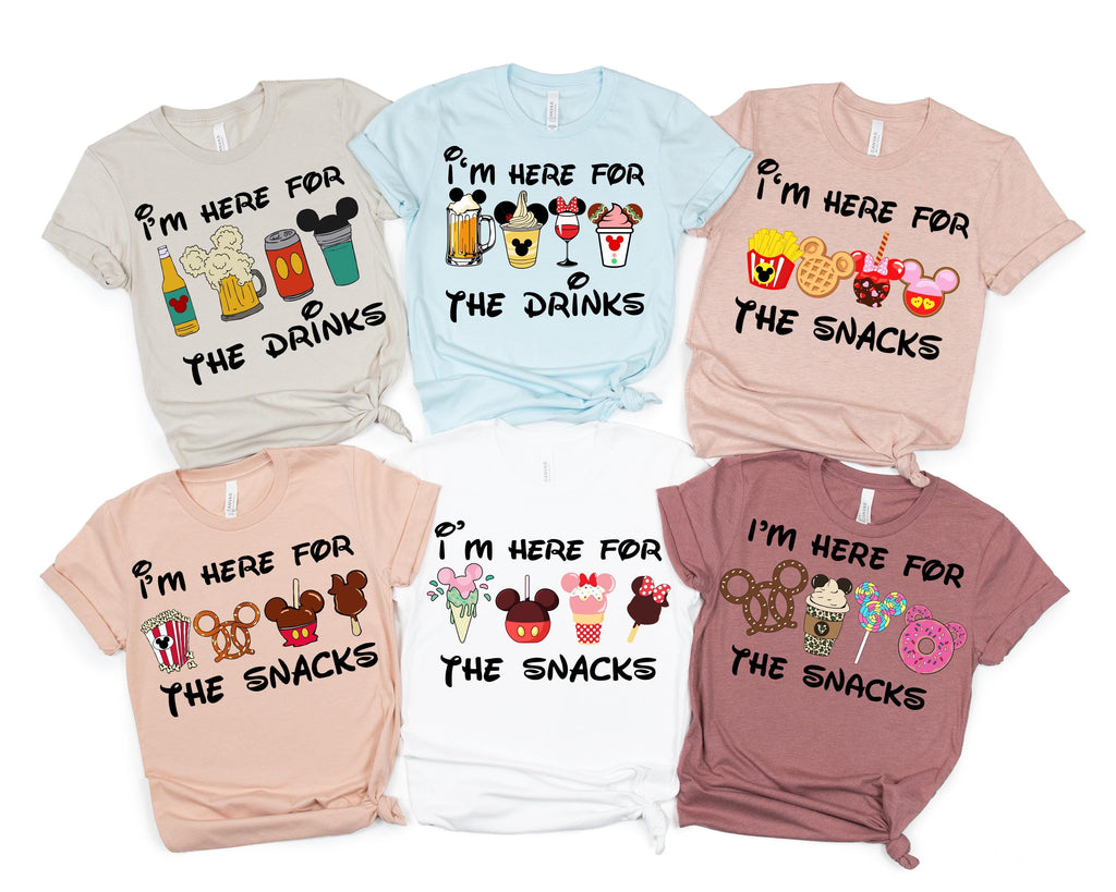 six t-shirts with various Disney-themed graphics and text, including Mickey Mouse and other popular characters, along with phrases like "I'm here for the drinks", "I'm here for the snacks", and "I'm here for the snacks".