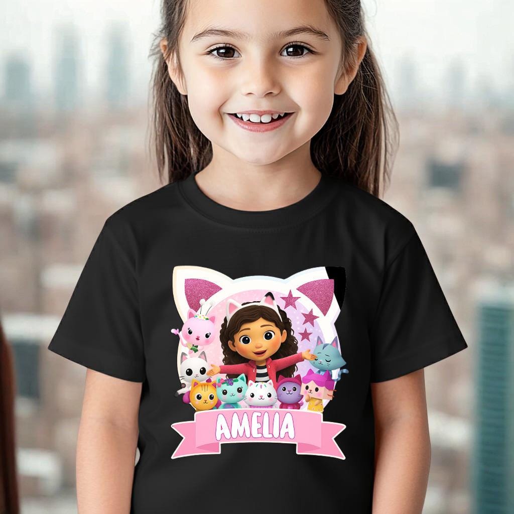 A young girl wearing a black t-shirt with a graphic design featuring a character surrounded by various cartoon animals.