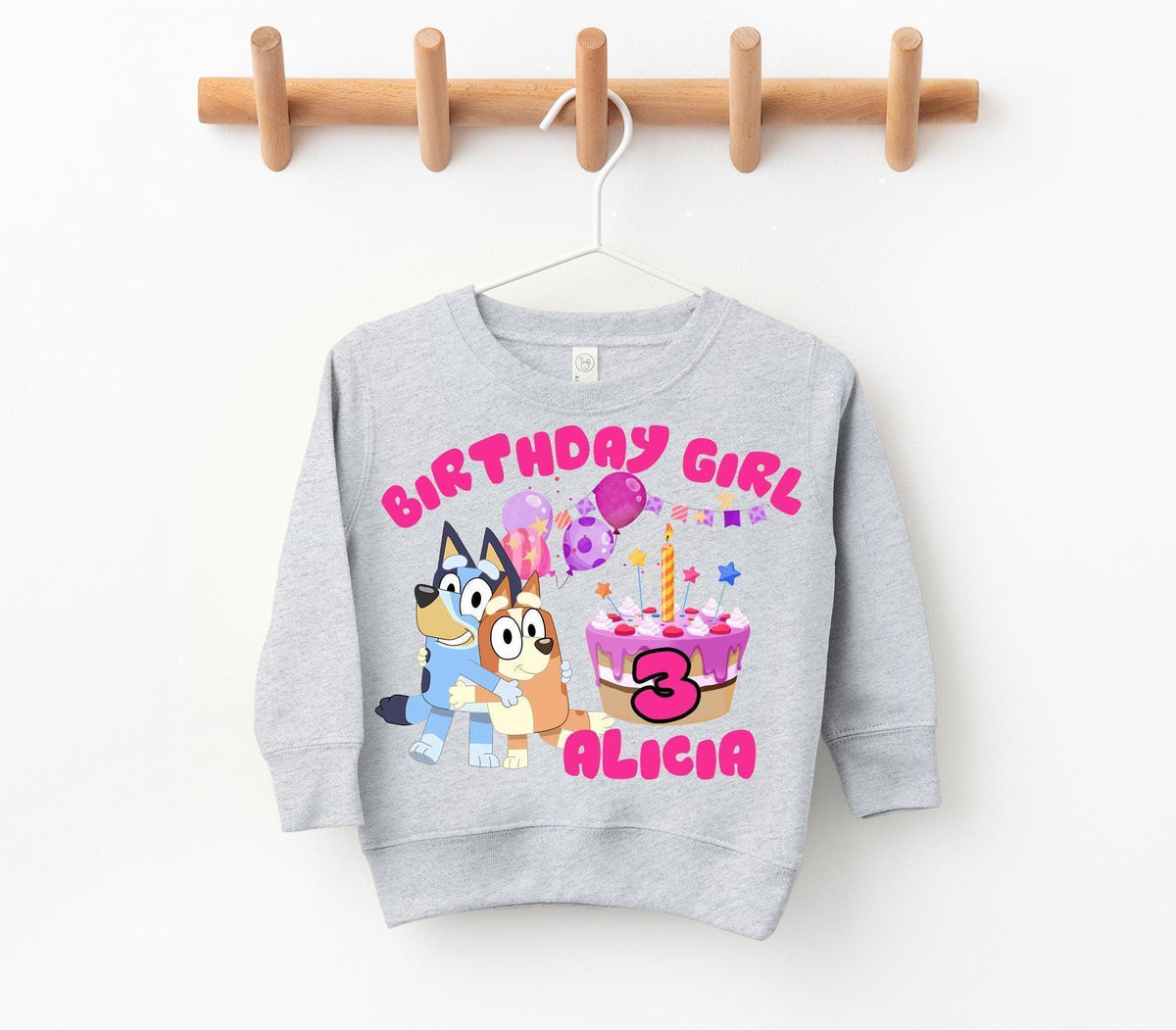 a birthday sweatshirt hanging on a clothes line