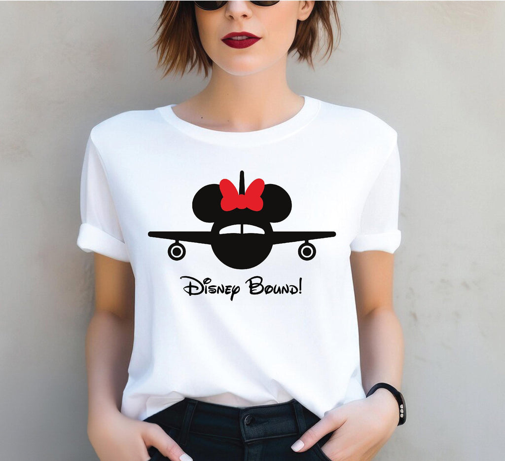 a woman wearing a mickey mouse shirt with a red bow