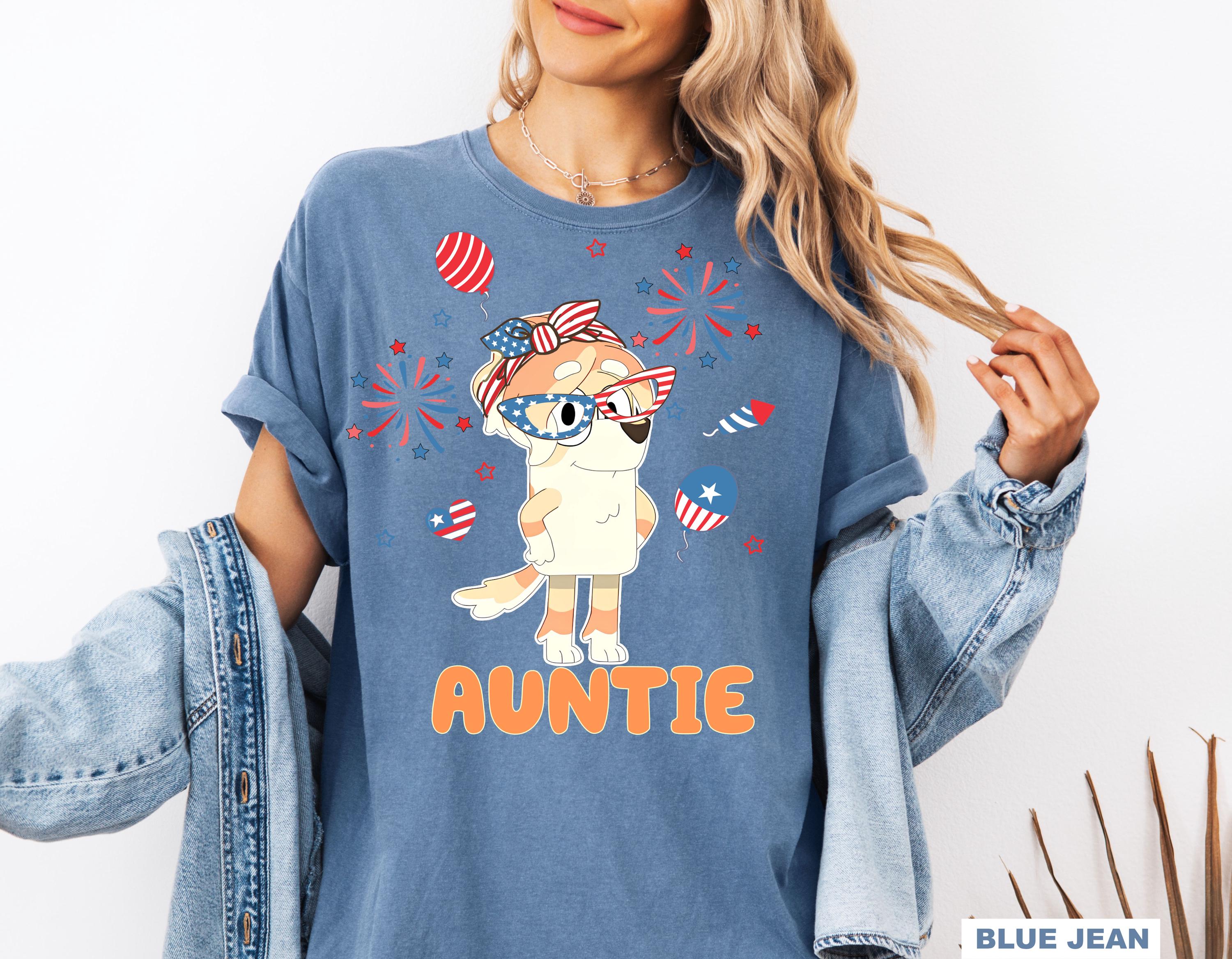 a woman wearing a blue shirt with an image of an animal on it