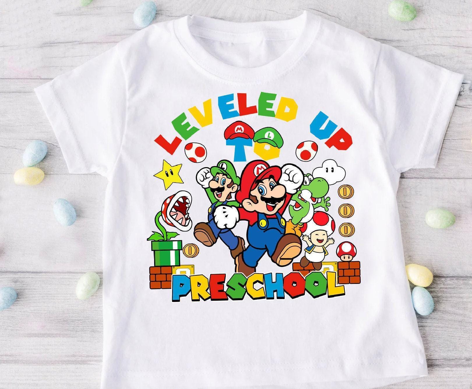 a white t - shirt with an image of mario and luigi on it
