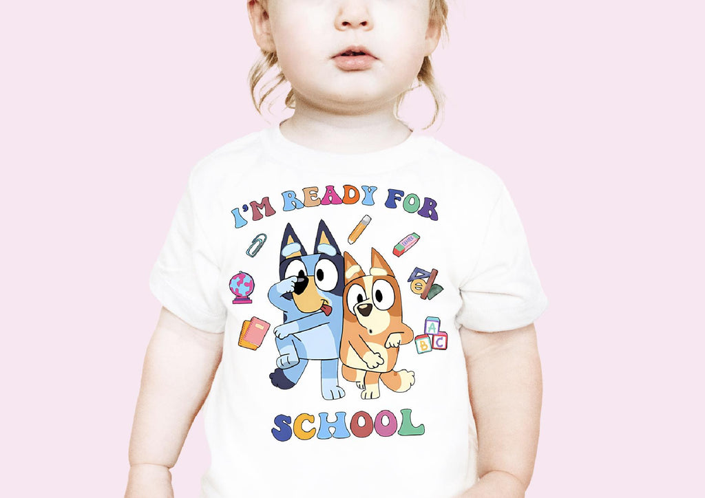 a toddler wearing a t - shirt with a cartoon character on it