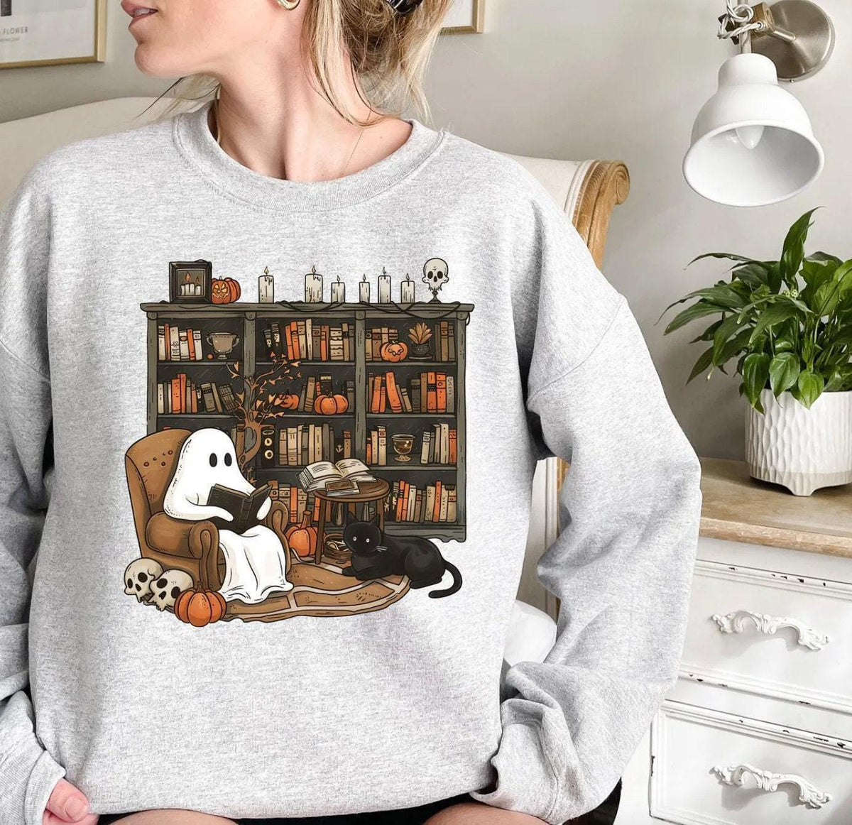 a woman wearing a sweatshirt with a dog and cat on it