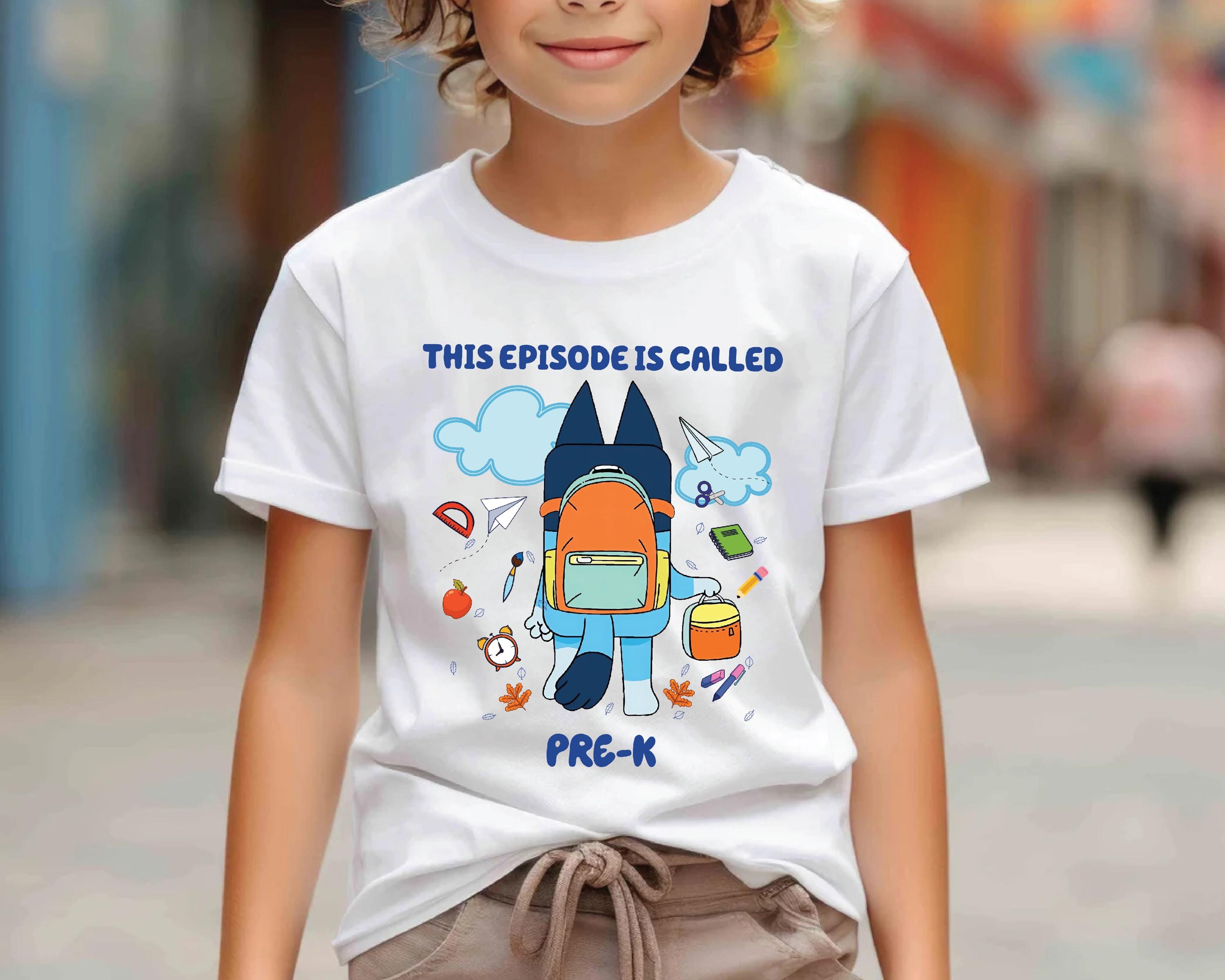 a young boy wearing a white t - shirt with a spaceman on it