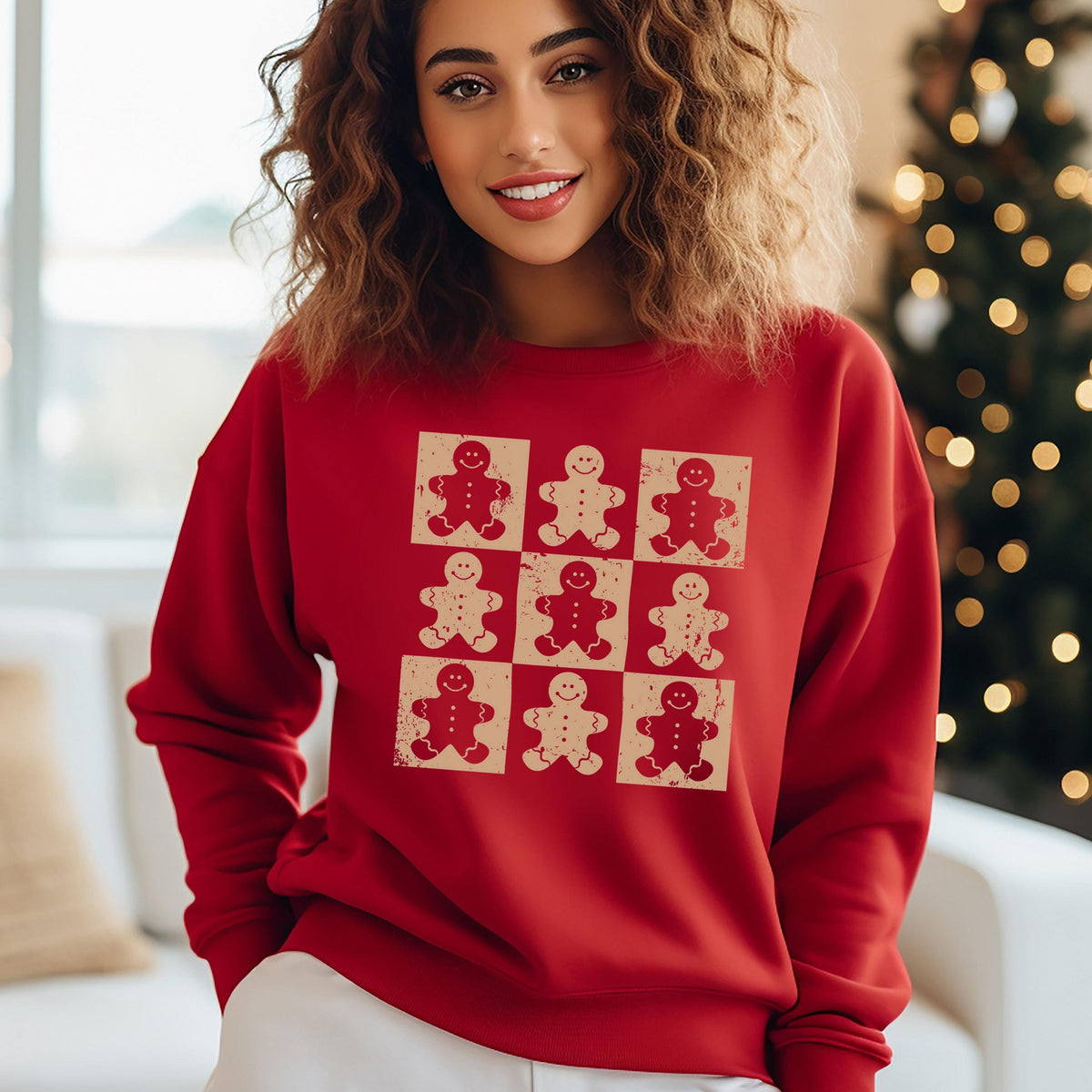 A woman wearing a red sweater with a graphic of nine smiling gingerbread men.