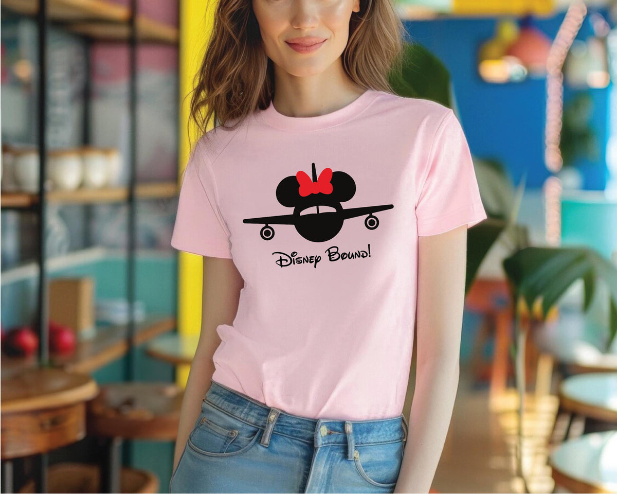 a woman wearing a pink disney mouse t - shirt