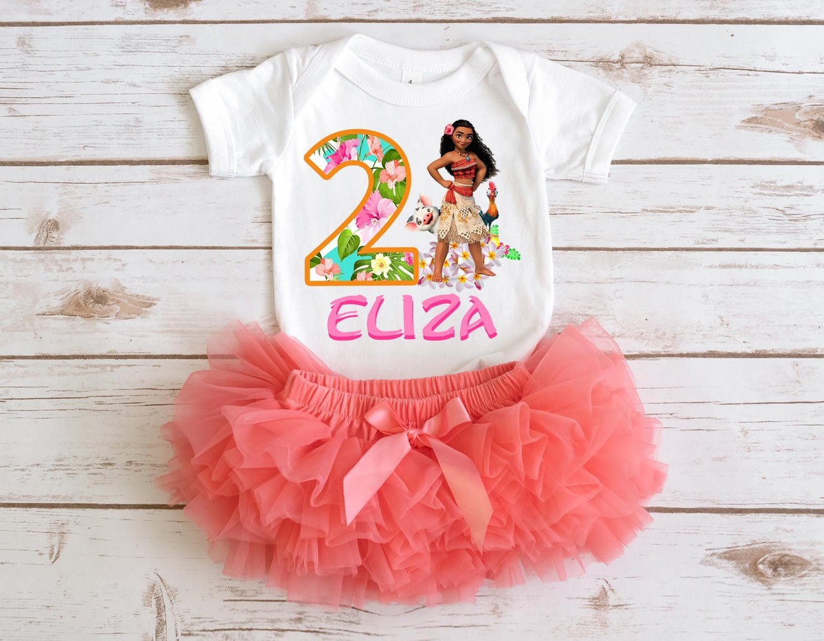 A white t-shirt with a printed image of a young girl and the text "2 ELIZA" printed on it, along with a pink tutu skirt.