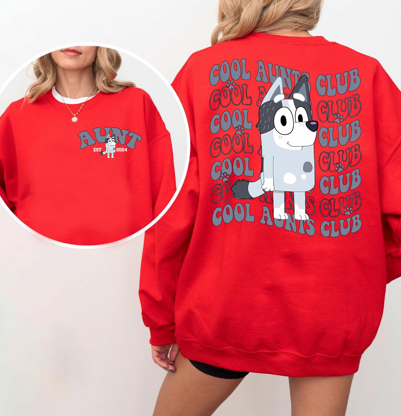 a woman wearing a red sweatshirt with a dog on it