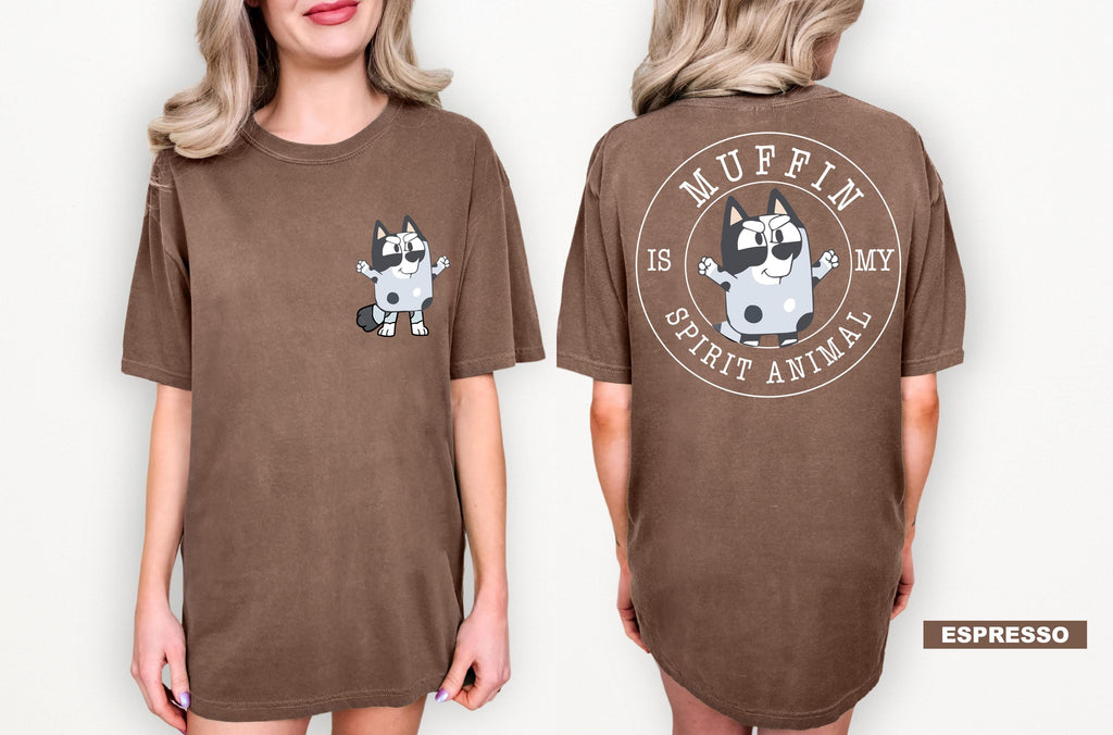 A woman wearing a brown t-shirt with a cartoon character and text printed on the back.