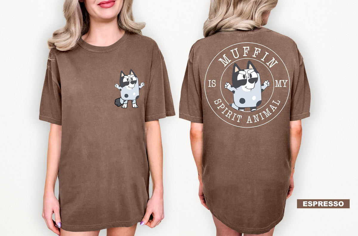 A woman wearing a brown t-shirt with a cartoon character and text printed on the back.