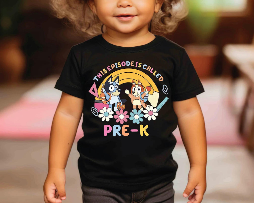 a little girl wearing a black shirt with cartoon characters on it