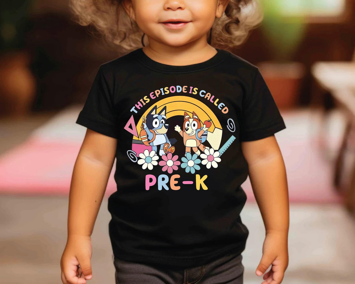 a little girl wearing a black shirt with cartoon characters on it