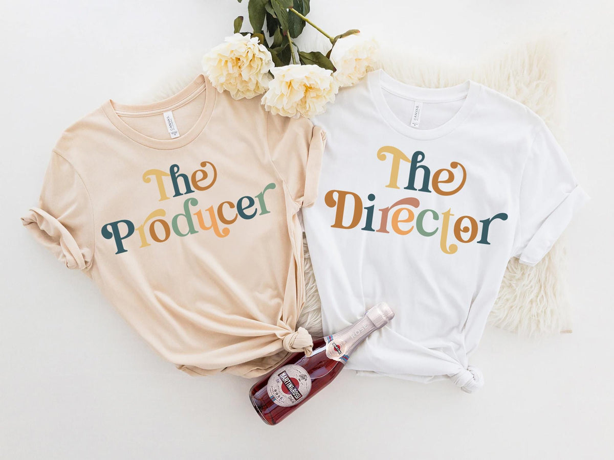 two t - shirts with the word the producer on them next to a bottle of