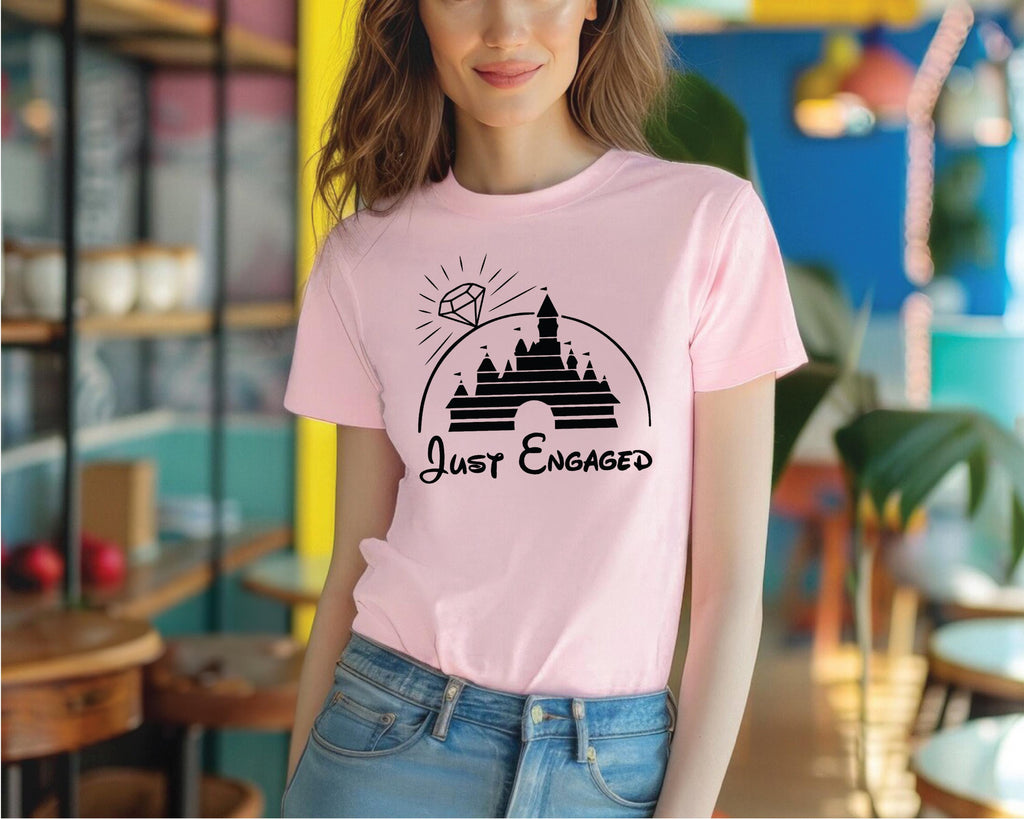 a woman wearing a pink t - shirt that says just engaged