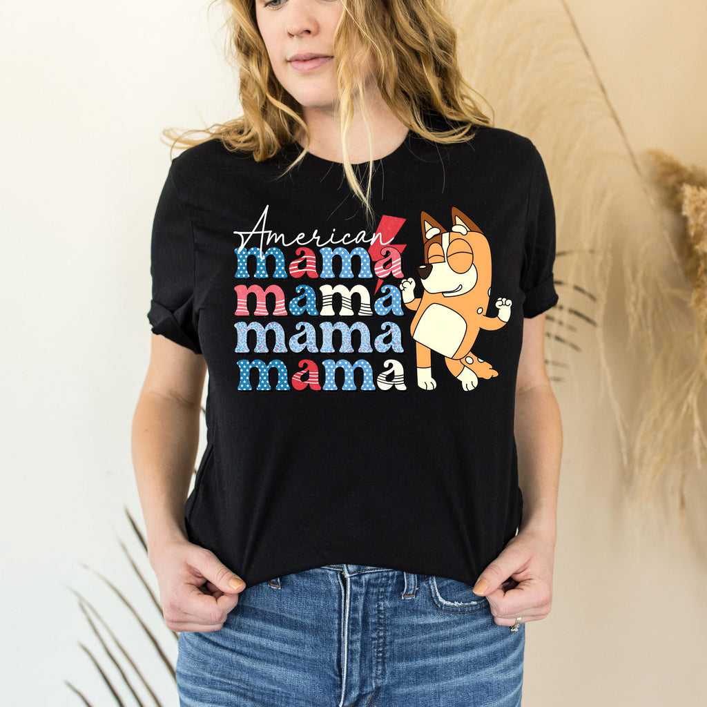 a woman wearing a black mama mama shirt
