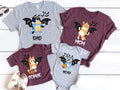 a collection of t-shirts featuring cartoon bat characters, likely from the animated series Bluey the Bat. The t-shirts are arranged on a white background, with some shoes placed nearby.