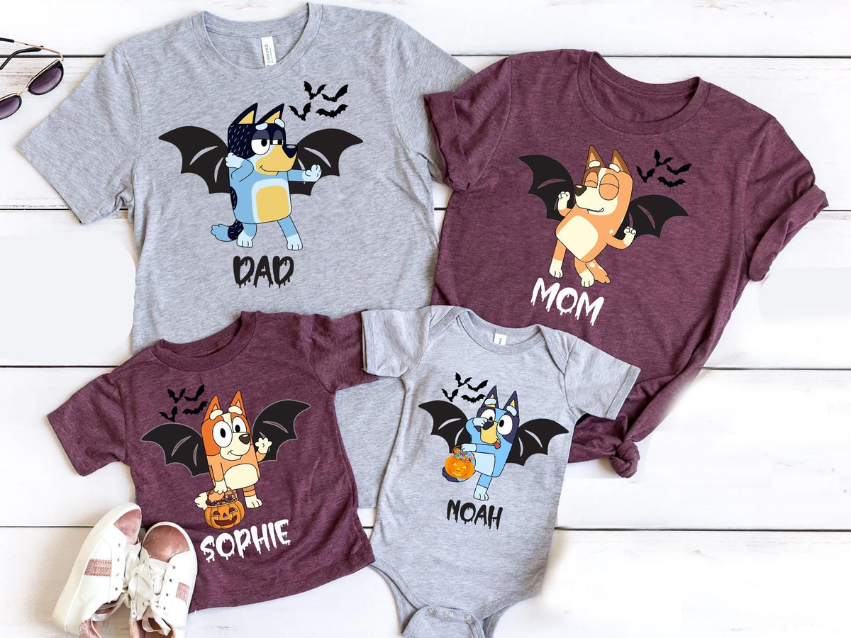 a collection of t-shirts featuring cartoon bat characters, likely from the animated series Bluey the Bat. The t-shirts are arranged on a white background, with some shoes placed nearby.