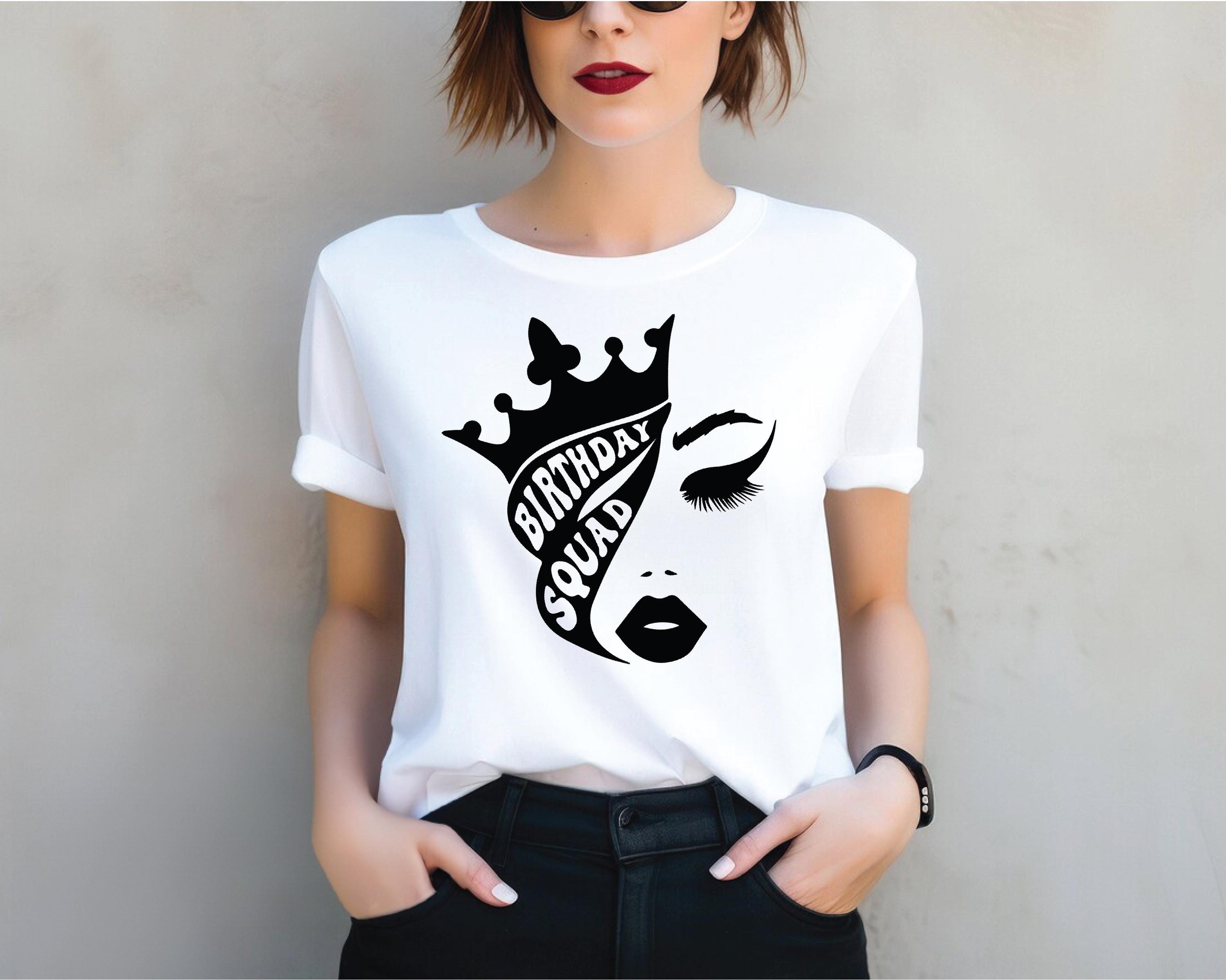 a woman wearing a t - shirt with a crown on it