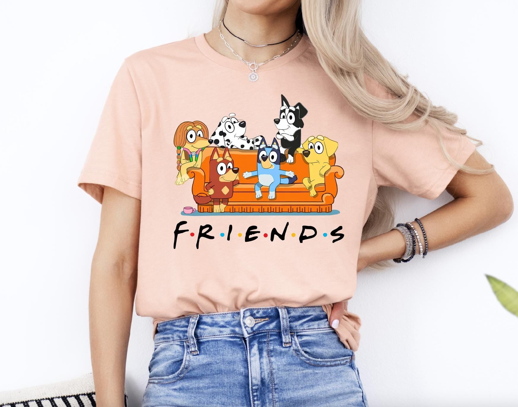 a woman wearing a pink shirt with cartoon characters on it