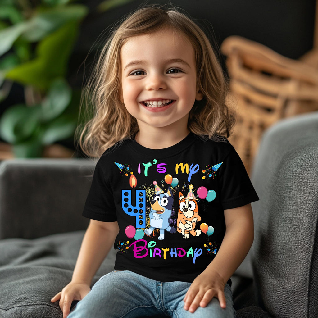 a little girl sitting on a couch wearing a birthday shirt