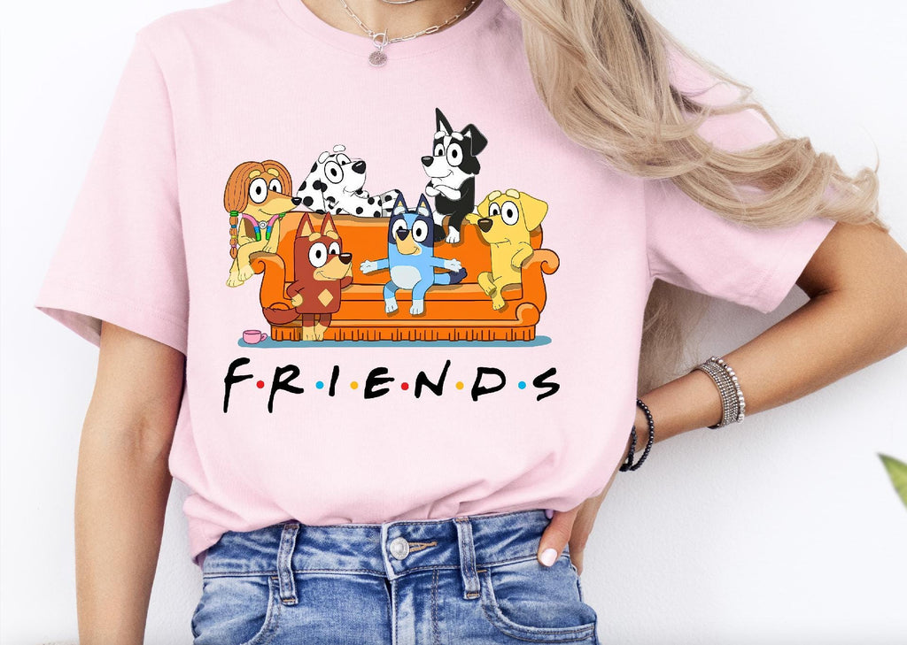 a woman wearing a pink shirt with cartoon characters on it