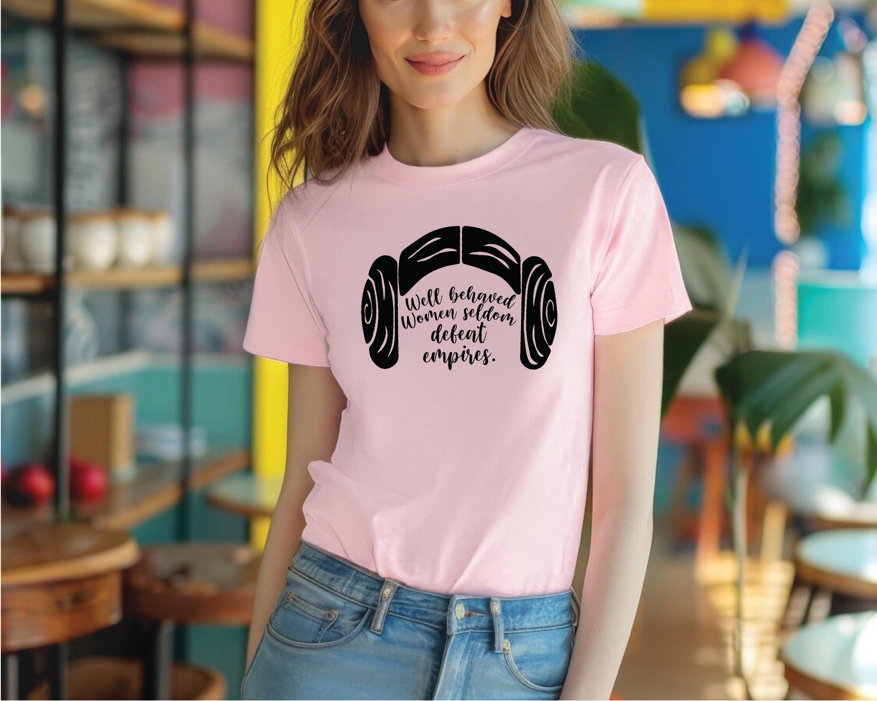 a woman wearing a pink t - shirt with a pair of headphones on it