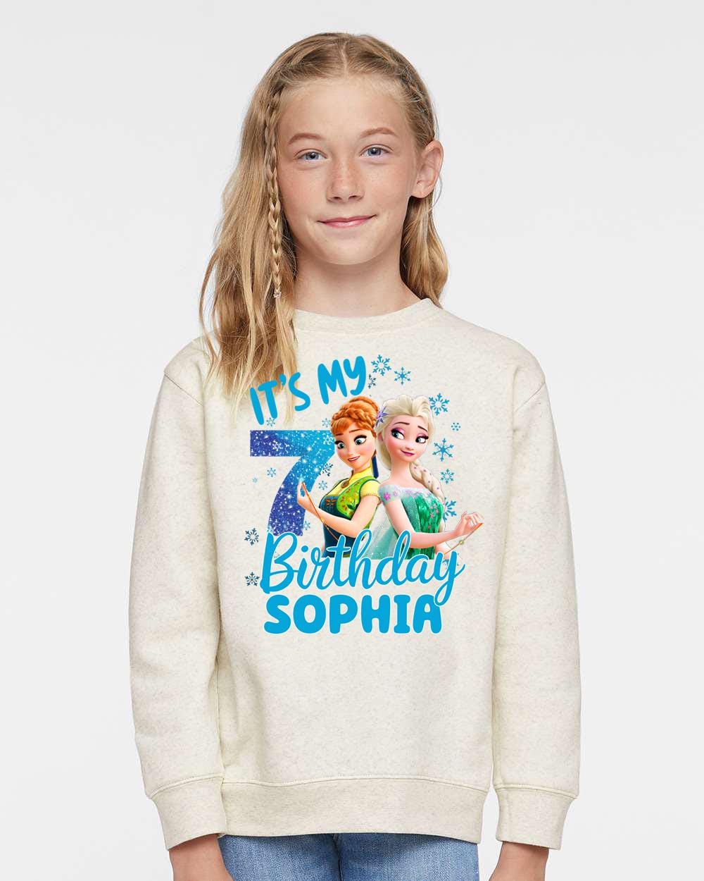 a young girl wearing a sweatshirt with a frozen princess image on it